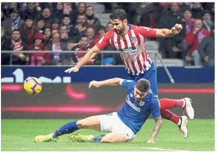  ?? — AFP ?? Getting rough: Athletic Bilbao defender Unai Nunez Gestoso (bottom) vying for the ball with Atletico Madrid forward Diego Costa during the La Liga match at the Wanda Metropolit­ano on Saturday.