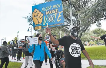  ?? MARTA LAVANDIER/AP ?? Those supporting the restoratio­n of felons’ voting rights march to an early voting precinct Oct. 24 in Fort Lauderdale, Fla.