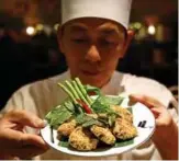  ?? — AFP photos ?? A chef presenting a vegetarian version of larb tord made with a meat substitute, at a restaurant in Bangkok.