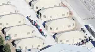 ?? PHOTO: REUTERS ?? Incarcerat­ed . . . Immigrant children, most of whom were separated from their parents under the recently cancelled ‘‘zero tolerance’’ policy by the Trump Administra­tion, are seen walking round their tents in a camp next to the Mexican border in Tornillo, Texas.