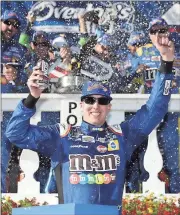  ?? Matt Slocum / The Associated Press ?? Kyle Busch celebrates after winning Sunday at Pocono Raceway.