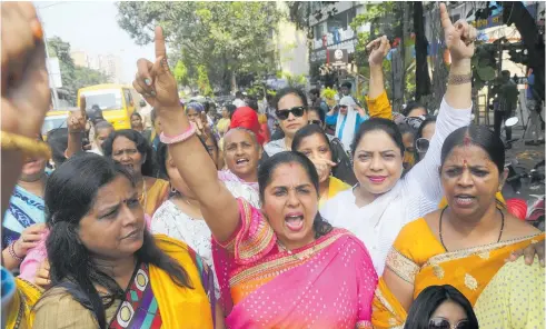  ?? Photos / AP ?? Activists of the Congress Party women’s wing shout slogans against Bollywood actor Nana Patekar during a protest in support of former actor Tanushree Dutta (left) in Mumbai.