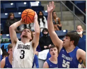  ?? (Special to the NWA Democrat-Gazette/Brian Sanderford) ?? Greenwood’s Caleb Ligon (left) puts up a shot Friday while being defended by Greenbrier’s Josh Robinson during the second quarter of the Bulldogs’ 50-44 victory over the Panthers at H.B. Stewart Bulldog Arena in Greenwood. Ligon finished with 11 points.