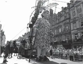  ??  ?? A giant marionette, known as the “Giant Grandmothe­r”, is paraded through the streets of Liverpool on Friday. The parade, entitled “Memories of August 1914”, by French theatre company Royal de Luxe, features a giant grandmothe­r, a giant little girl and...