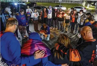  ?? DARRON CUMMING/AP ?? Football fans gather outside of University of Cincinnati Medical Center on Tuesday in Cincinnati to send support to Buffalo Bills player Damar Hamlin, who was taken to the hospital after collapsing on the field Monday night during a game against the Bengals.