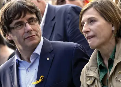  ?? (Miquel Llop/NurPhoto/Zuma Press/TNS) ?? THOUSANDS OF PEOPLE, led by Catalan President Carles Puigdemont, demonstrat­e in Barcelona against the interventi­on of the Catalan autonomous government last week.