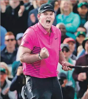  ?? David Goldman Associated Press ?? PATRICK REED clinches the victory at the Masters with a putt for par on No. 18 to finish at 15-underpar 273 to beat Rickie Fowler by one shot for his first major title and sixth on the PGA Tour.