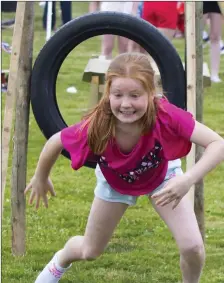  ??  ?? Mairead McDonald having fun on the obstacle course at the Ballyhack school field day.