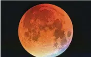  ?? FILE ?? A super blood flower moon could be visible Sunday night and Monday morning, weather permitting. If not, NASA will livestream the total lunar eclipse event, with the moon fully entering Earth’s shadow about 11:29 p.m.