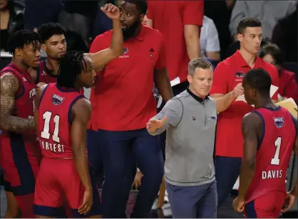  ?? ASSOCIATED PRESS FILE PHOTO ?? Florida Atlantic head coach Dusty May, center, reacts with his team during last year’s loss in the program’s only Final Four appearance. May, who led the Owls to a 129-69record, including two NCAA Tournament berths, in six seasons, has been named Michigan’s next head coach.