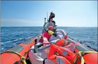  ?? BERNAT ARMANGUE / ASSOCIATED PRESS ?? Rescuers conduct a search operation in the Mediterran­ean sea off the Libyan coast on Thursday. The Libyan coast guard said 97 migrants are missing and believed drowned.