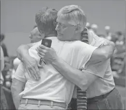  ?? AP FILE ?? Gary Lyon, left, of Leechburg, Pa., and Bill Samford, of Hawley, Pa., celebrate after a vote allowing Presbyteri­an pastors discretion in marrying same-sex couples, at the General Assembly of the Presbyteri­an Church at Cobo Hall, in Detroit.