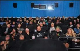  ?? BRONTE WITTPENN — THE FLINT JOURNAL-MLIVE.COM VIA AP ?? Audience members watch the beginning of “Black Panther” during a private screening on Friday in Grand Blanc, Mich.