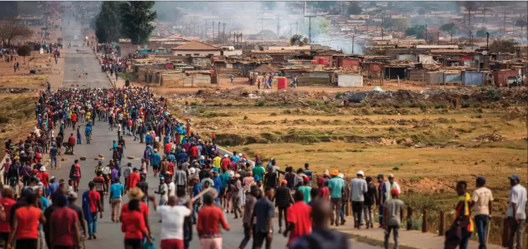  ?? Photo: Nampa/AFP ?? Harassment… In this file photo, taken on 5 September 2019, a mob, armed with spears, batons and axes run through Johannesbu­rg’s Katlehong township during a new wave of anti-foreigner violence.