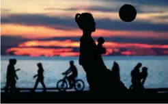  ??  ?? PLAY TIME – It’s time for some soccer as these kids frolic in the beach of Boracay. (EPA)