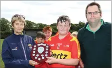  ??  ?? Horeswood captain William Foley with Angela McCormack (Coiste na nOg) and Dean Goodison, representi­ng People Newspapers.