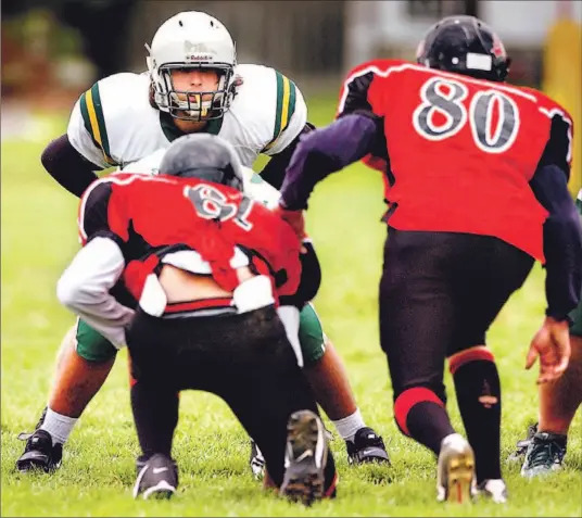  ?? CARLOS OSORIO/TORONTO STAR ?? Frank Aiello (white helmet), a 6-3, 255-pound running back, is enjoying a great year with the Pickering Trojans. Says his coach: He’s strong as an ox with exceptiona­l agility.’