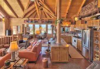  ?? Photos by Ben Zimmerman ?? The 2,867-square-foot log cabin-styled getaway at 146 Blanda Circle in the off-thegrid village of Cold Creek is listed for $794,900. It sits on a nearly 3¼-acre lot.