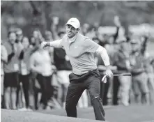  ?? THE ASSOCIATED PRESS ?? Rory McIlroy reacts after making an eagle on the eighth hole Saturday during the third round of the Masters. He is in second place.