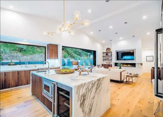  ?? Photograph­s courtesy of Shawn Cordon Real Estate Photograph­y ?? THE STUDIO CITY home with a low profile keeps its flash to itself: Inside is an open-plan space with bright, modern decor.