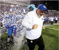  ?? ARKANSAS DEMOCRAT-GAZETTE FILE PHOTO ?? Players douse Bryant head coach Buck James with a bucket of ice water after the Hornets’ win in the Class 7A state-championsh­ip game.