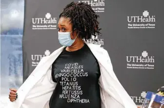  ?? Karen Warren / Staff photograph­er ?? Jeffeea Gullett, MD, an internal medicine physician at UT Physicians Multispeci­alty–Victory clinic, shows off her vaccine T-shirt earlier this month.