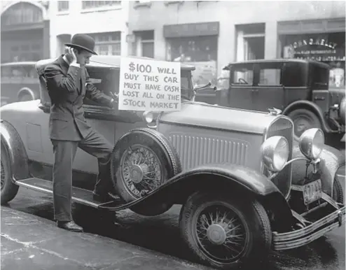  ?? GETTY IMAGES ?? Bankrupt investor Walter Thornton tries to sell his luxury roadster for $100 on the streets of New York City
following the 1929 stock market crash. We’re not quite at that point, but 2022 does not look auspicious.