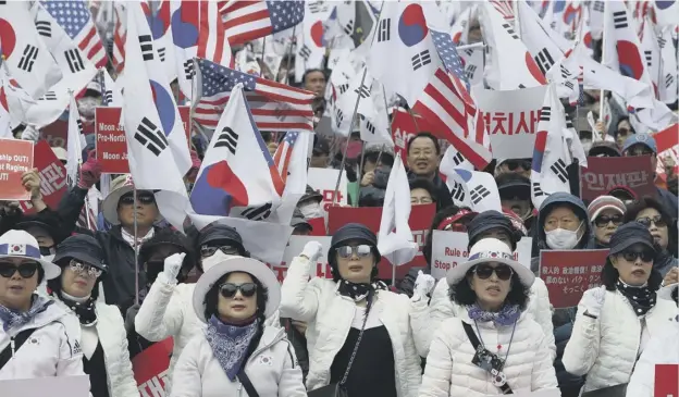  ?? PICTURE: GETTY IMAGES ?? Supporters of former president Park Geun-hye participat­e in a rally in front of the Seoul Central District Court yesterday