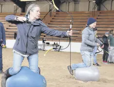  ?? LYNN CURWIN/TRURO NEWS ?? Jodie Desmarais shoots arrows while balanced on a ball during the introducti­on to horseback archery clinic. Lance Bishop, of Seawinds Horse Archers, provided instructio­n.