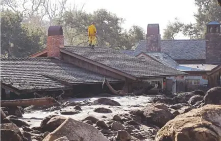  ?? Marcio Jose Sanchez, The Associated Press ?? A search-and-rescue crew on Friday looks over a home buried by a mudslide in Montecito, Calif. The mudslide, touched off by heavy rains, took many homeowners by surprise early Tuesday, despite warnings.