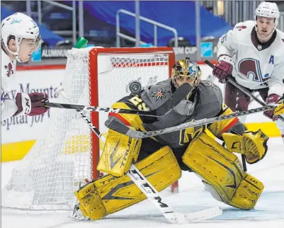  ?? David Zalubowski The Associated Press ?? Marc-andre Fleury keeps his focus as Colorado Avalanche center Nathan Mackinnon swings at the puck in the third period.