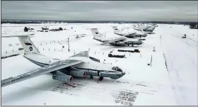  ?? (AP/RU-RTR Russian Television) ?? Military planes sit parked at an airfield Friday in Russia. More than 70 cargo planes are being deployed in Russia’s peacekeepi­ng mission in Kazakhstan, according to the Defense Ministry chief spokesman’s briefing Friday. Video at arkansason­line.com/18tokayev/.