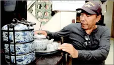  ?? ?? These Chinese tea set and tiffin owned by Zai Am still look presentabl­e despite being hundreds of years old.