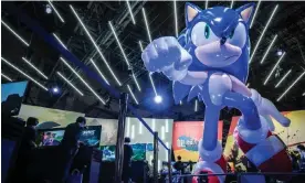  ?? Photograph: Yuichi Yamazaki/AFP/Getty Images ?? Visitors play games next to a model of Sonic the Hedgehog at the Tokyo Game Show in Chiba prefecture in September 2022.