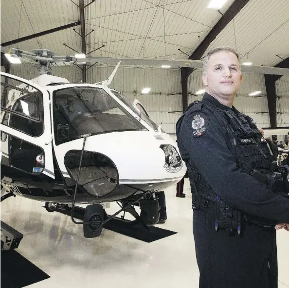  ?? GREG SOUTHAM ?? Sgt. Murray Maschmeyer, chief pilot of the Edmonton Police Service’s flight operations unit, stands in front of the new state-of-the-art Air-1 helicopter on Friday. The Airbus H-125 is used by more than 200 law enforcemen­t agencies around the world.