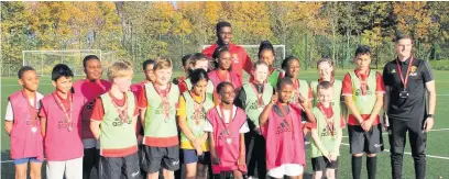  ??  ?? ●●Axel Tuanzebe out on the sports pitch with youngsters