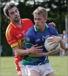  ??  ?? Fionn Cooney of Glynn-Barntown holds on to possession as Eddie Shiely (Horeswood) challenges.