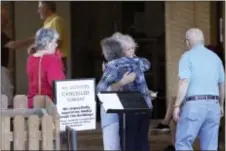  ?? TOM REEL/THE SAN ANTONIO EXPRESS-NEWS VIA AP ?? People greet each other outside First Baptist Church after hearing news of the deaths of several members who attended the church in New Braunfels, Texas, Wednesday.