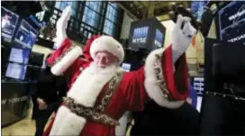  ?? RICHARD DREW — THE ASSOCIATED PRESS FILE ?? Santa Claus visits the trading floor of the New York Stock Exchange Wednesday before the opening bell. Stocks have already exceeded most expectatio­ns in 2017, and it looks like Santa Claus will drop by to give investors another gift before the year...