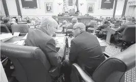  ?? BOB BROWN/RICHMOND TIMES-DISPATCH ?? Del. Barry Knight, R-Va Beach, left, chair of the House Appropriat­ions Committee, confers with Del. Luke Torian, D-Prince William, right, during the floor session of the House of Delegates inside the State Capitol in Richmond on March 9. Torian, former chair of the committee, is one of the House budget bill conferees.