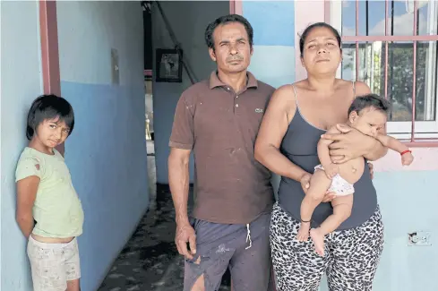  ??  ?? DEADLY OUTBREAK: Tulio Medina and Jennifer Vivas, parents of Eliannys Vivas, who died from diphtheria, pose for a photo with two of their children at their home in Pariaguan, Venezuela.