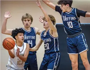  ?? JIM WEBER/NEW MEXICAN FILE PHOTO ?? Mesa Vista forward Jordan Gallegos passes against Santa Fe Prep’s Oren Putnam, from left, Oliver Winkler and Morgan Field on Jan. 12 in a semifinal in Santa Fe Indian School’s Braves Invitation­al.