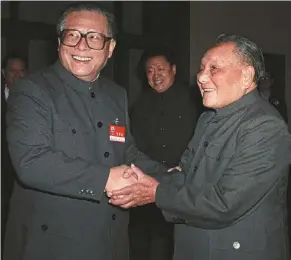  ?? — Xinhua ?? In good company: Jiang being greeted by cpc leader deng Xiaoping at the fifth plenary session of the 13th communist Party of china (cpc) central committee, held in beijing from nov 6 to 9, 1989.