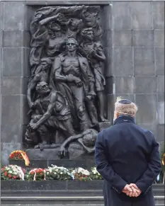  ?? Czarek Sokolowski / Associated Press ?? A wreath is laid at the monument to the Heroes of the Warsaw Ghetto in Warsaw, Poland, on Jan. 2 to recognize Holocaust victims.