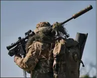  ?? (AP/Libkos) ?? A Ukrainian army sniper changes position Tuesday near Bakhmut in the Donetsk region of eastern Ukraine.