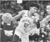  ?? BRANDON DILL AP ?? The Grizzlies’ Ja Morant, who had 27 points and 14 assists, drives on the Lakers’ Avery Bradley.