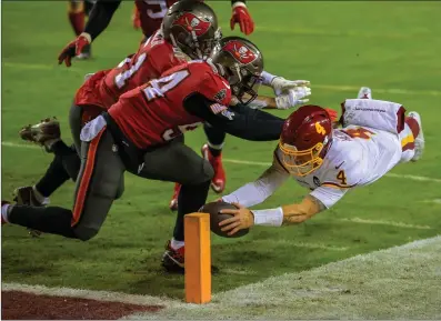  ?? Washington Post photo ?? The No. 5 Tampa Bay Buccaneers played solid defense in Saturday night’s win over Tyler Heinicke, right, and Washington. The Buccaneers are back on the road Saturday night when they face No. 2 New Orleans in the Divisional Round.