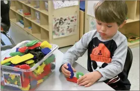  ??  ?? ABOVE: South Rome Early Learning Center student Noah Bryson works with bristle blocks to build at the start of the day. The center for 3-year-olds is housed at Anna K. Davie Elementary. BELOW: South Rome Early Learning Center teacher Cayce Jacobson...