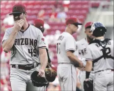  ?? JEFF DEAN/AP ?? ARIZONA DIAMONDBAC­KS STARTING PITCHER TYLER GILBERT leaves during the second inning of the team’s game against the Reds on Tuesday in Cincinnati.