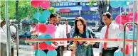  ??  ?? Hunter and Co PLC Managing Director L.R.P. Dossa ceremonial­ly cutting of the ribbon with Sales and Marketing General Manager Ruwan Singhabahu at the new showroom, as Moratuwa Sales Executive Sumith Wanasinghe looks on